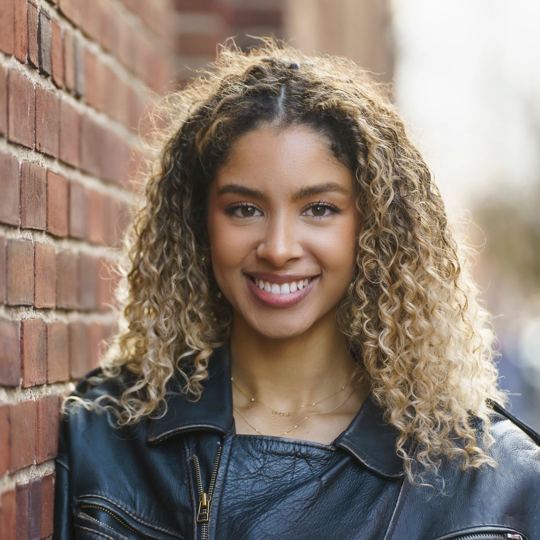 Portrait of a smiling student with curly hair