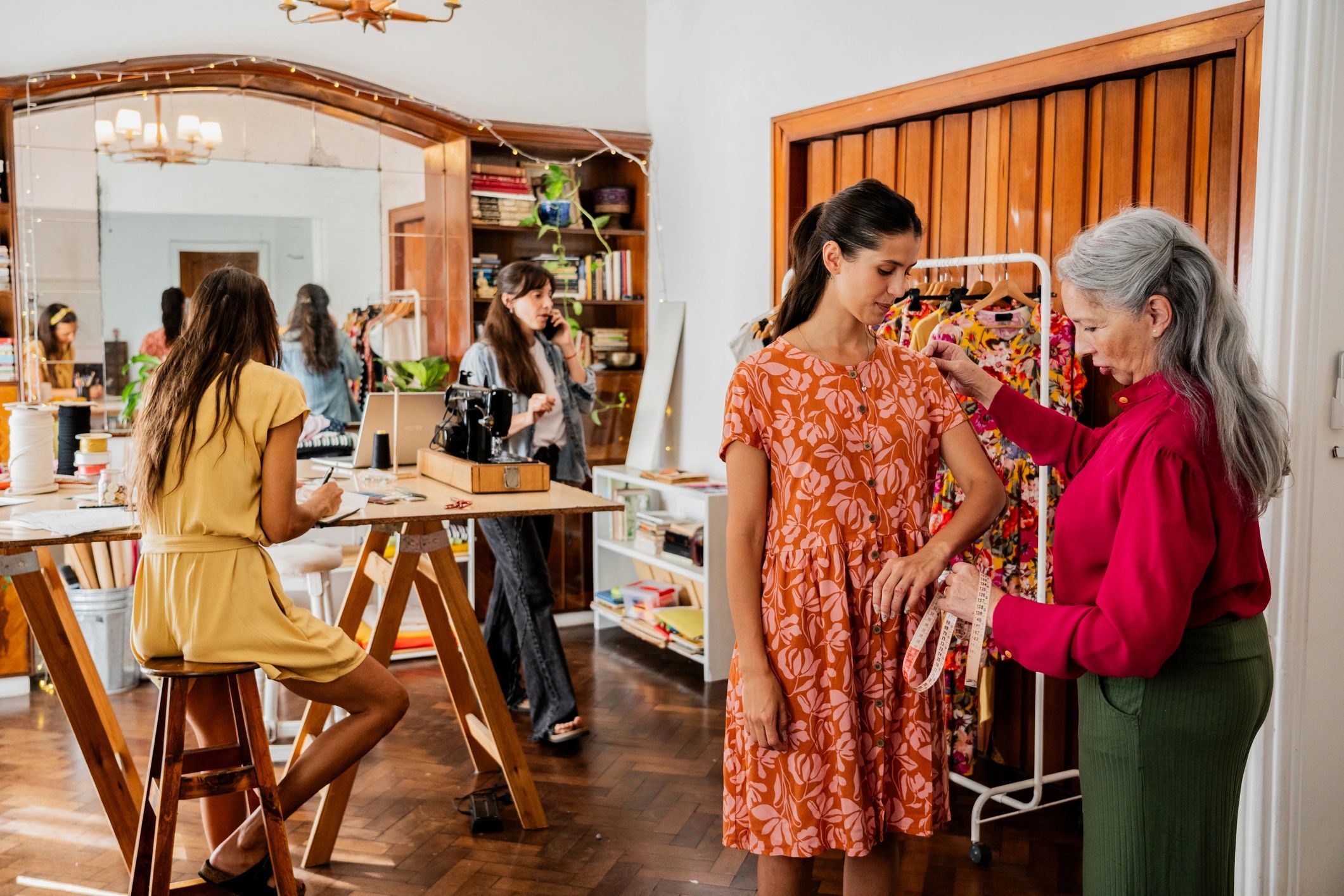 Seamstress taking measurements in an atelier