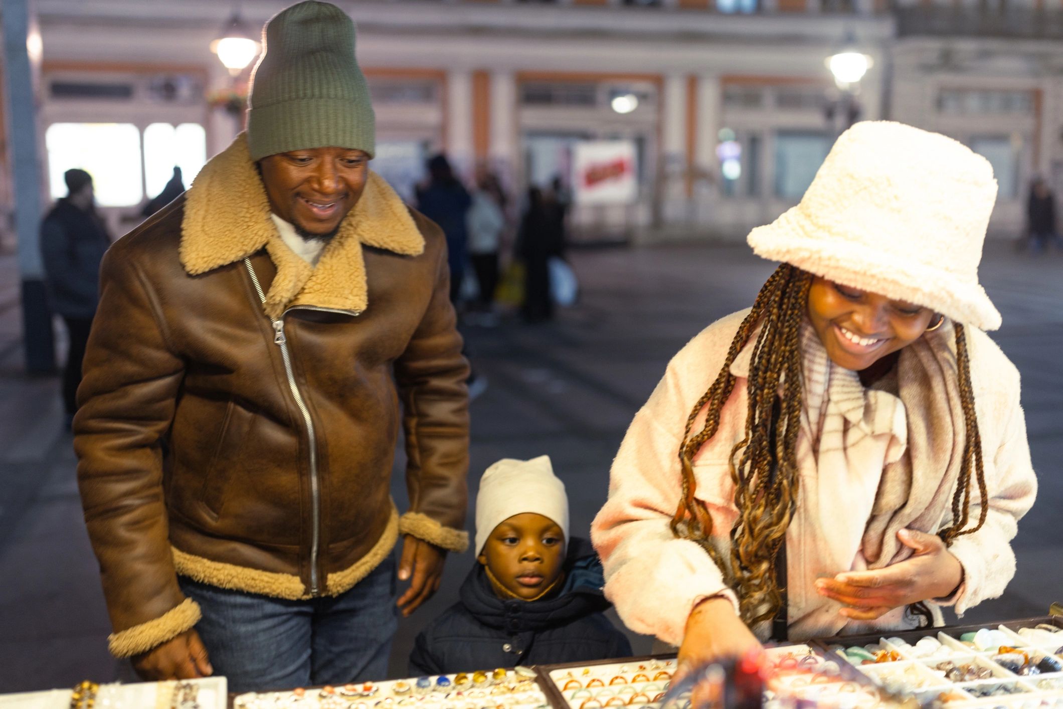 Shoppers browsing handmade accessories at a street market