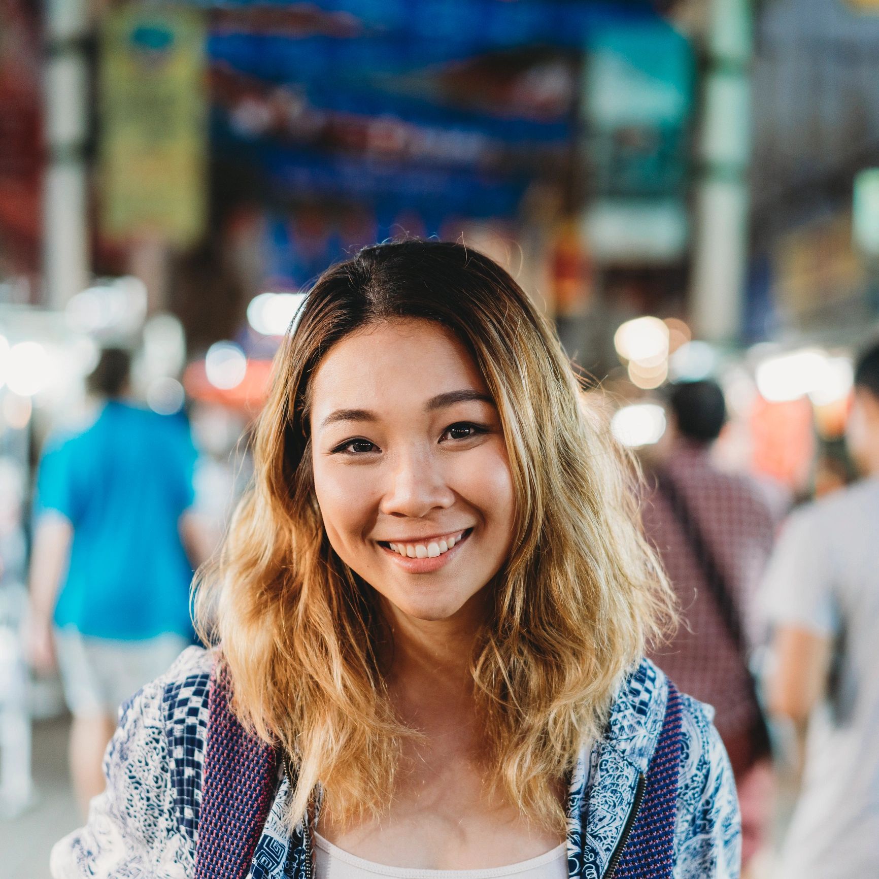 Portrait of a young adult woman in a city at night